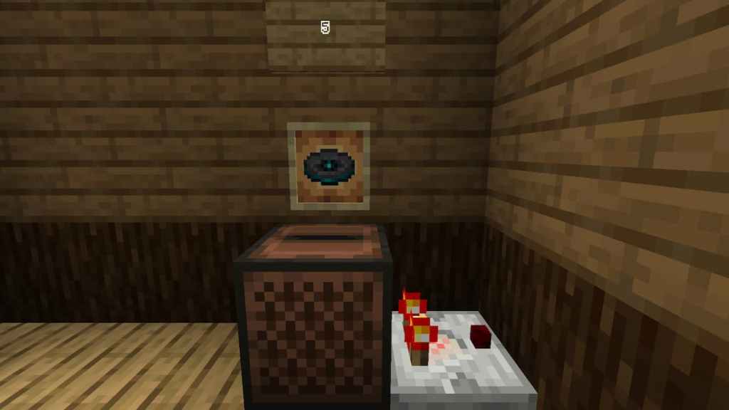 Using music disc 5 to power a Redstone Comparator in Minecraft