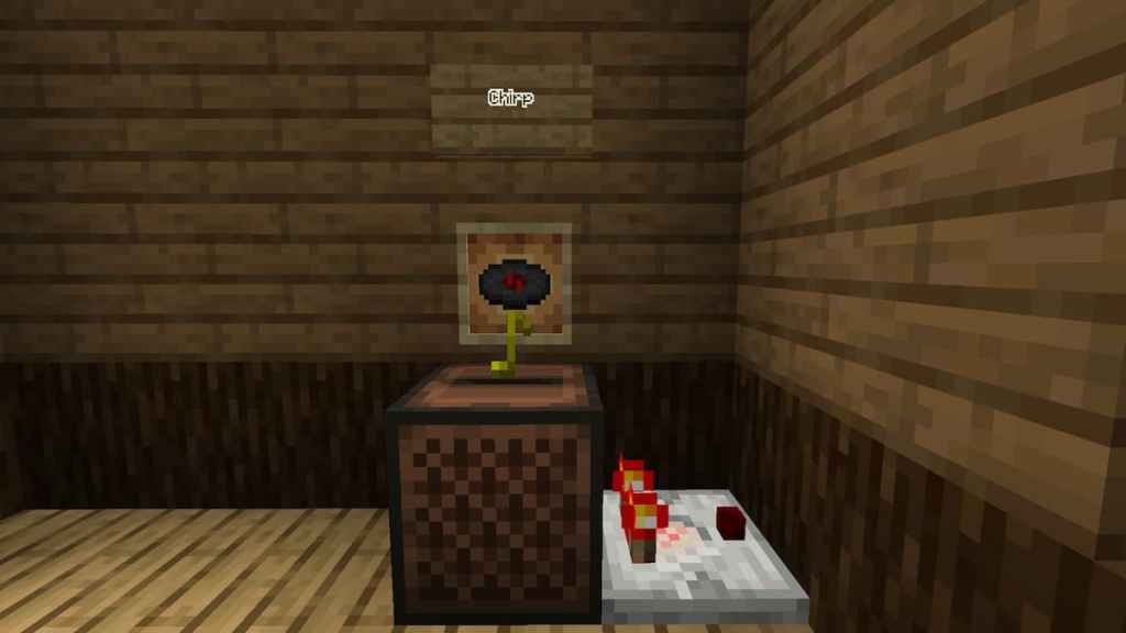 A Redstone Comparator being powered by a jukebox playing the Chirp disk