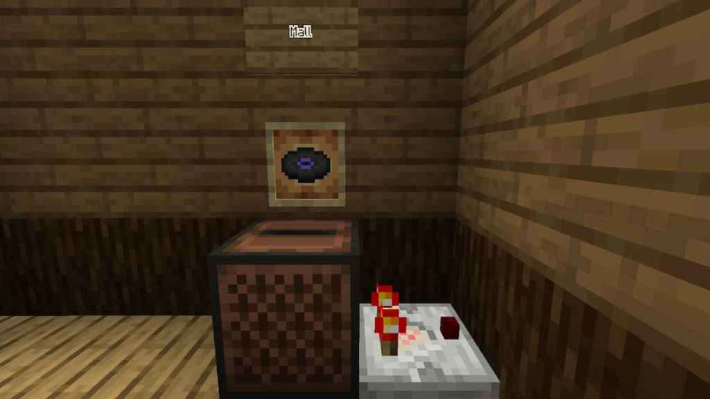 Playing the Mall music disk in a jukebox to power a Redstone Comparator