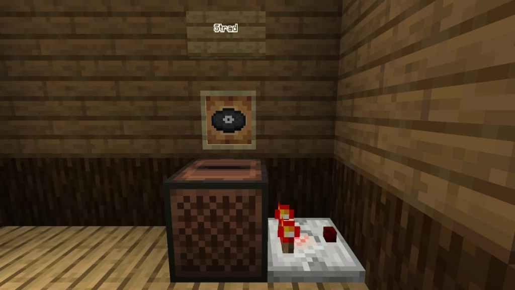 A Redstone Comparator next to a Jukebox containing the Strad music disc