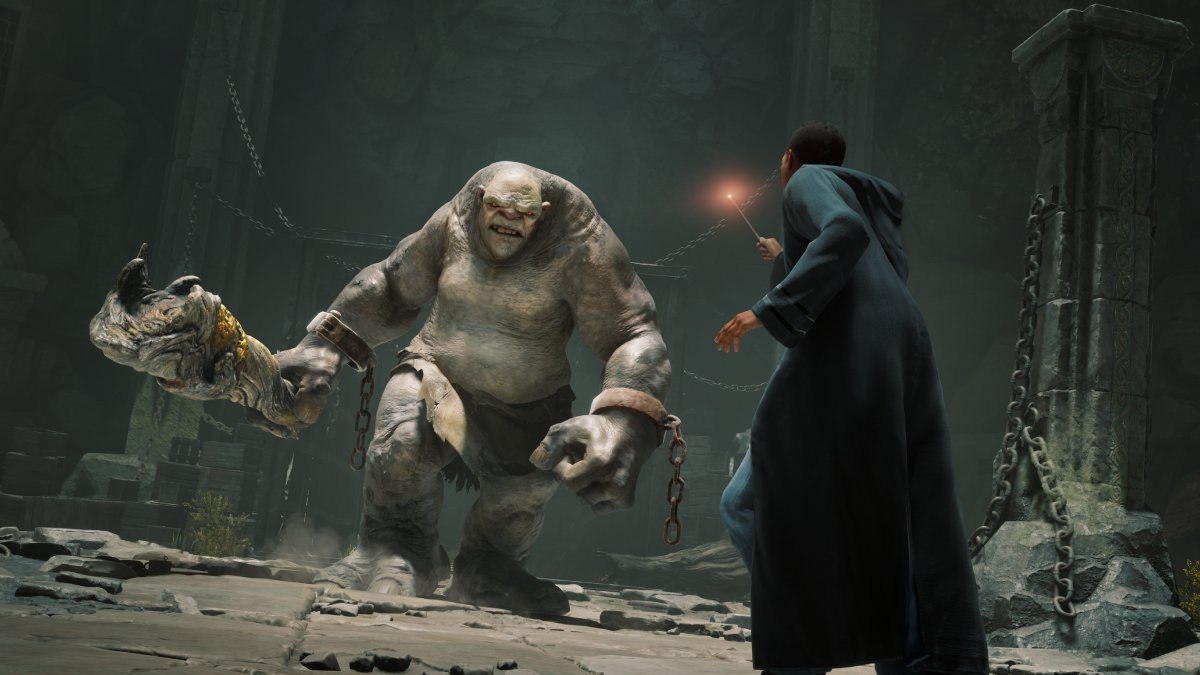 A wizard taking on a troll in Hogwarts Legacy