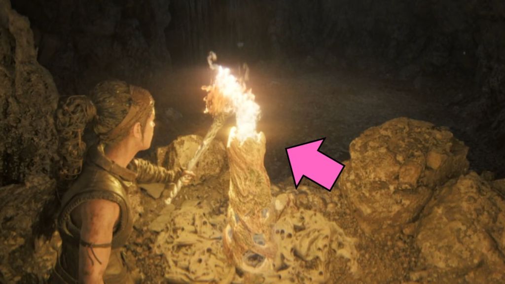 Lit torch in the caves in Hellblade II
