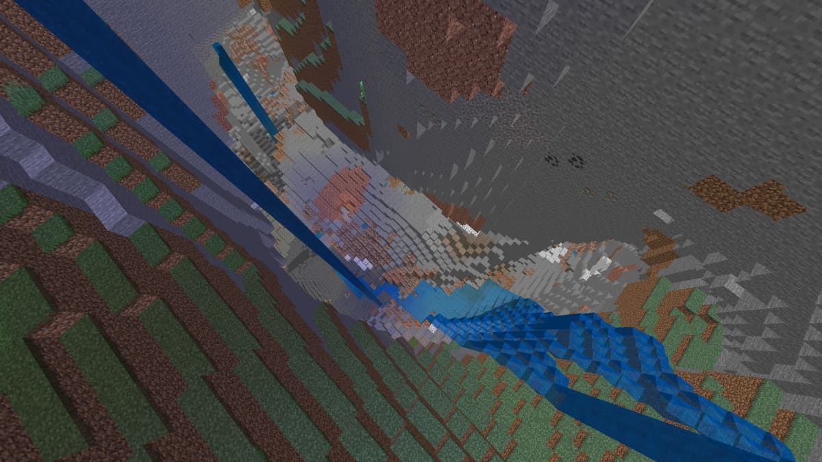 A deep crescent-shaped Minecraft cave with waterfalls